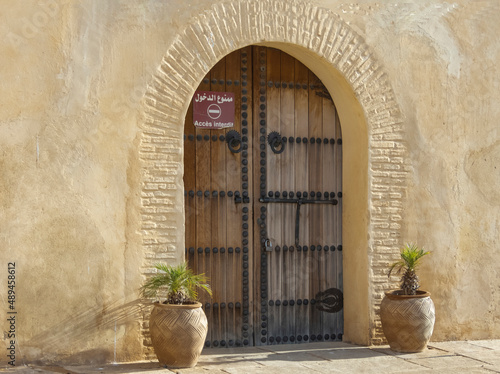 Doorway with terracotta pots and plants growing