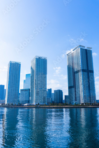 Tower apartments lined up along the river and a refreshing blue sky_23