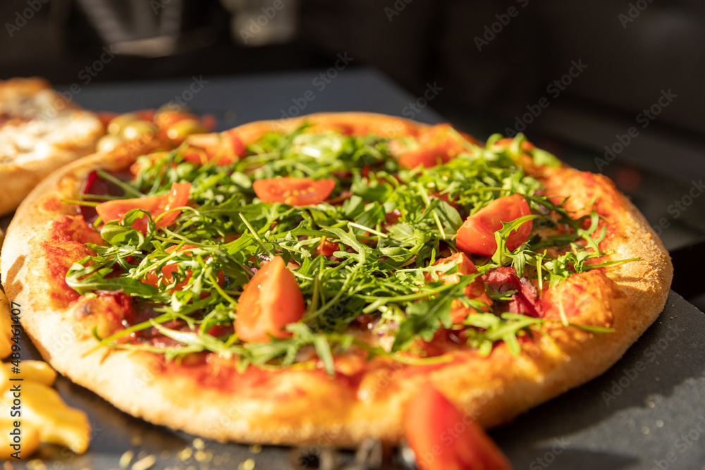 Crudo arugula pizza served in a restaurant