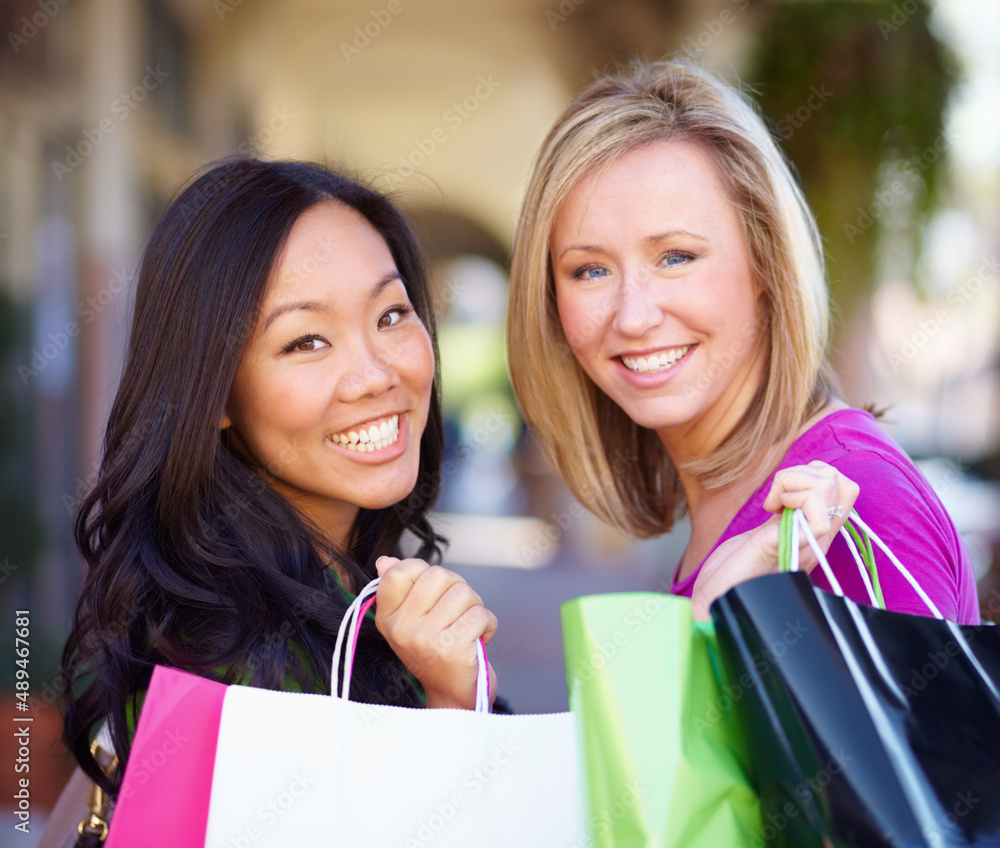 Ive got loads of clothes, I never have to go shopping,said no woman ever.. Portrait of a two young woman on a shopping spree.