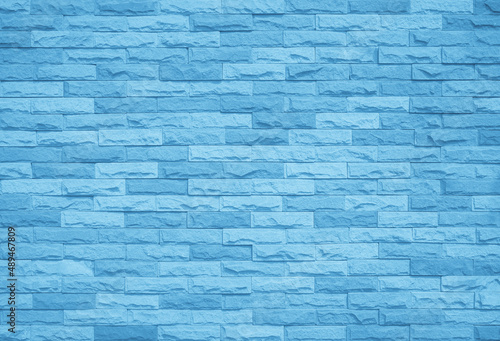 Brick wall painted with pale blue paint pastel calm tone texture background. 
