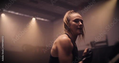 A Strong Man And Woman Sparring / Training In A Martial Arts Gym. Shot In A Crossfit Boxing Gym With Low Key Lighting And A Scattering Of Haze. Captured On Red Digital Cinema Camera 