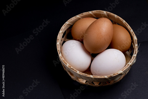 Wallpaper Mural Fresh eggs in basket,duck egg and chicken egg in basket, healty egg, black background   Torontodigital.ca