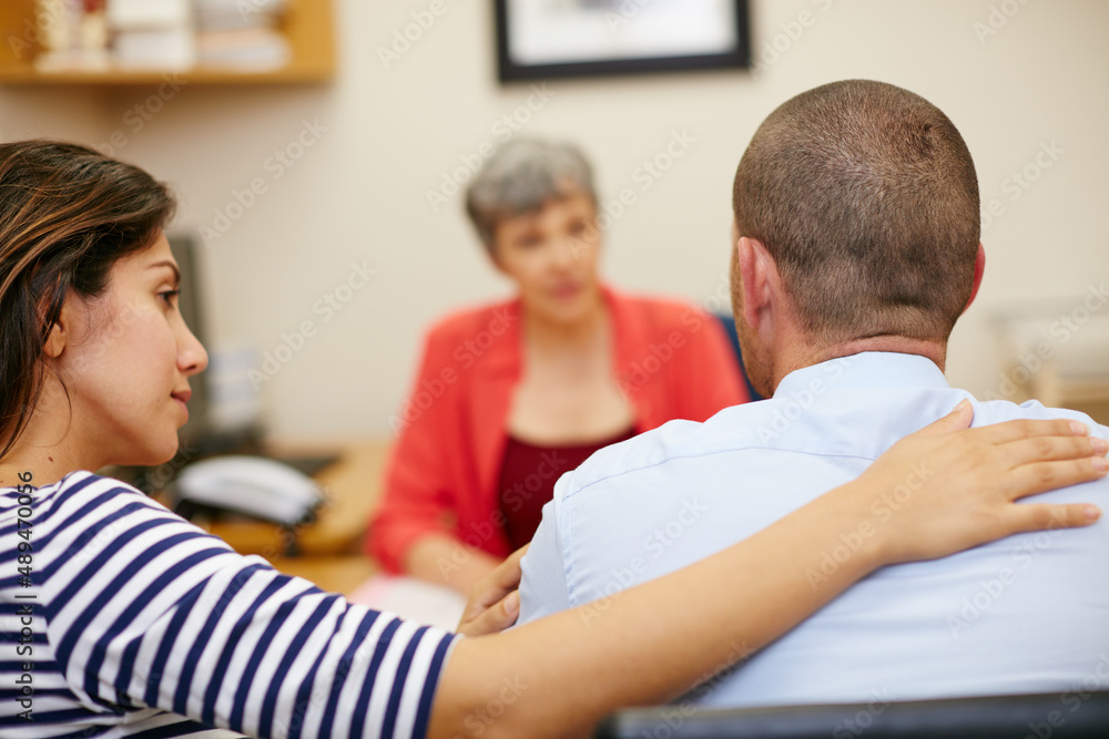 Obraz premium What do you think. Rearview shot of a couple sitting in a meeting with their financial advisor.