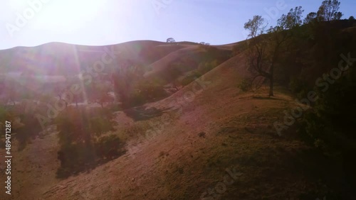 Beautiful outdoor ranch landscapes, vast golden mountain tops with long views of valleys and oak trees and incredible rolling hillsides all seen from an aerial view of California's most serene vistas.