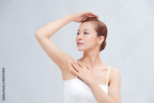 Beautiful Young Asian woman lifting hands up to show smooth armpit cleanliness and protection concept