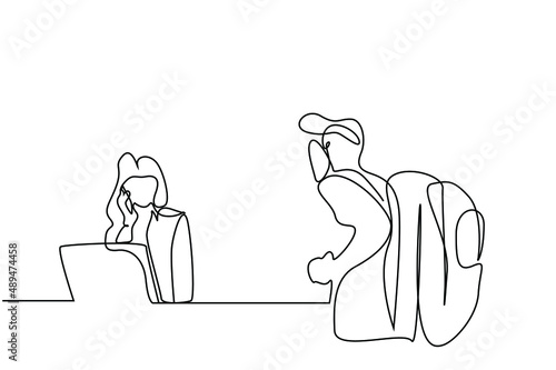 female employee checking incoming customer in front of a reception desk