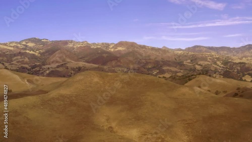 Beautiful outdoor ranch landscapes, shots of a overlanding Toyota 4Runner with a rooftop tent on an off road adventure, vast golden mountain tops with long views of valleys and oak trees and incredibl