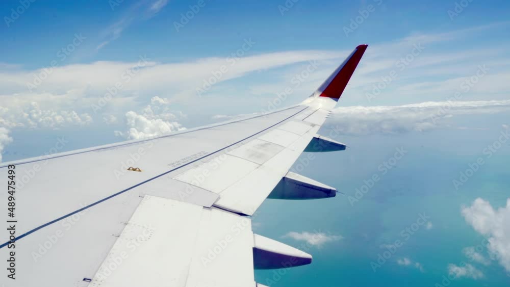 Transportation Video Aerial view from the aircraft window while flying through the cloud with golden light from the sun in the early morning or evening in travel and transportation concept Transportation Video Aerial view from the aircraft window while flying through the cloud with golden light from the sun in the early morning or evening in travel and transportation concept