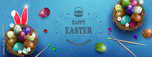 Blue postcard with Easter eggs and flowers in the nest, rabbit ears