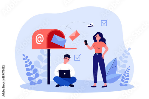 Open mailbox and tiny business characters with laptop and phone. Man and woman getting messages or letters online flat vector illustration. Communication, mail, newsletter concept for banner