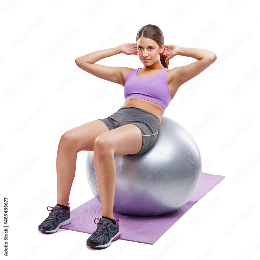 Fototapeta premium If it doesnt challenge you, it wont change you. Shot of a beautiful young woman doing exercises on her fitness ball.