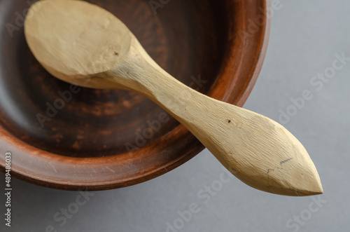 Canvas Print Brown earthenware bowl and buckshot against a gray background.