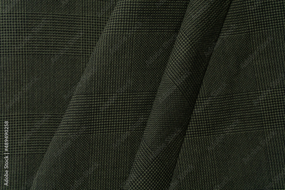 Fototapeta premium Green plaid fabric background close up 