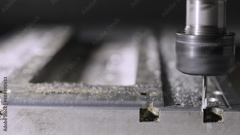 Automatic cnc turning milling machine cutting metal workpiece with shavings at factory. Metalworking, manufacturing concept. Metal workpiece is machined by an electric machine. Slow motion. Close up. Automatic cnc turning milling machine cutting metal workpiece with shavings at factory. Metalworking, manufacturing concept. Metal workpiece is machined by an electric machine. Slow motion. Close up.
