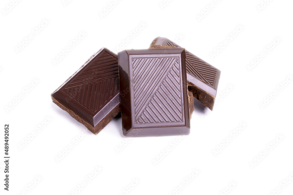 Three pieces of a piece of chocolate close up macro isolated on a white background Three pieces of a piece of chocolate close up macro isolated on a white background
