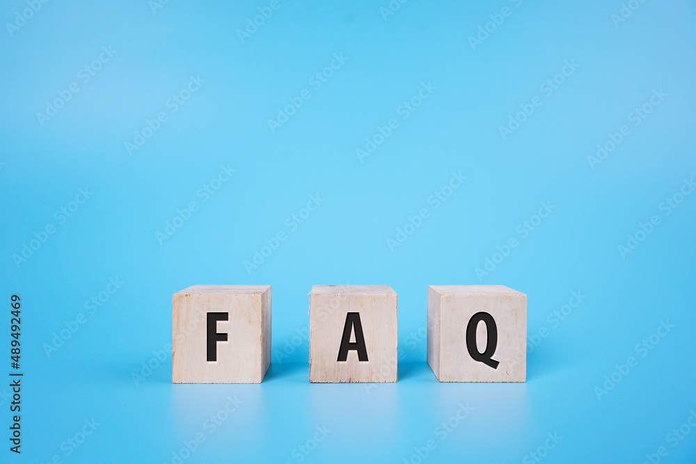 FAQ for Frequently asked question on a wooden block over blue background FAQ for Frequently asked question on a wooden block over blue background