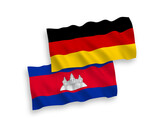 National vector fabric wave flags of Germany and Kingdom of Cambodia isolated on white background. 1 to 2 proportion.