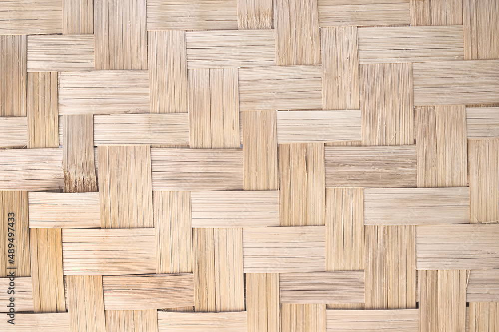 Woven bamboo wood wall texture crafts pattern on brown background Woven bamboo wood wall texture crafts pattern on brown background
