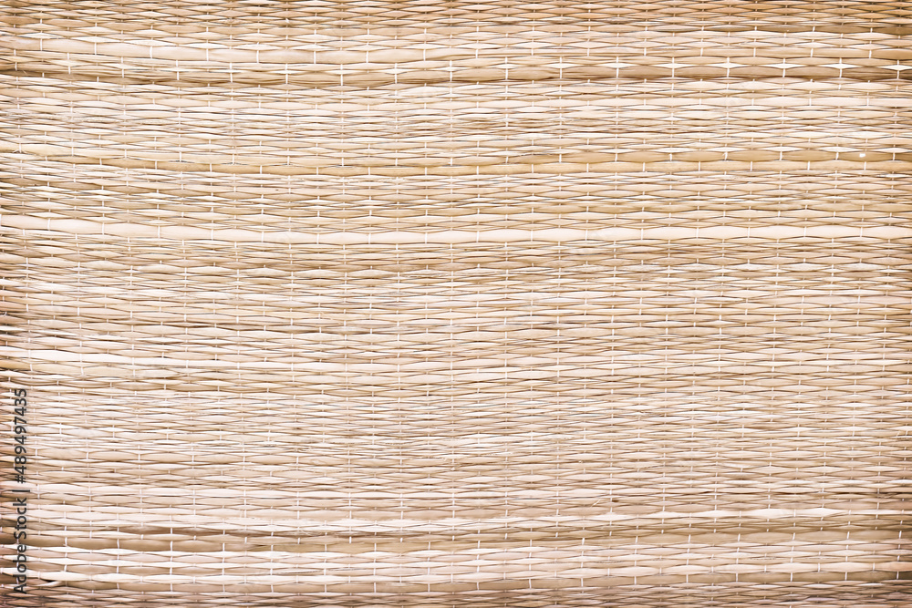 Close up straw mat texture with woven patterns for crafts background Close up straw mat texture with woven patterns for crafts background