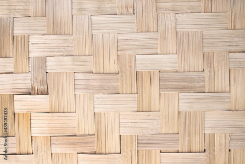 Woven bamboo wood wall texture crafts pattern on brown  background