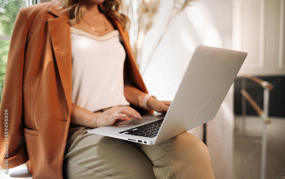 Fototapeta premium girl working on a laptop remotely or in the office