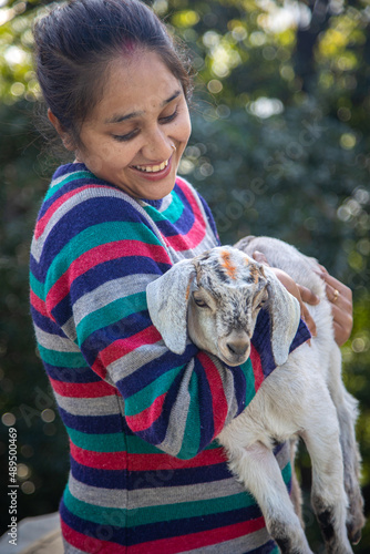 Close-Up Of Girl Holding Kid Goat