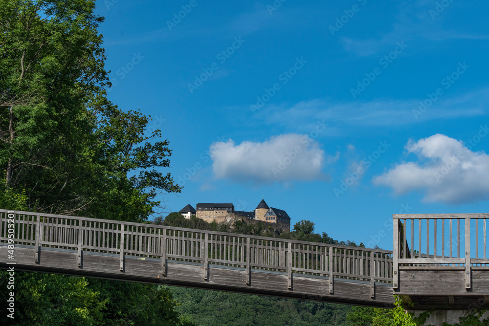 Waldeck Castle, a medieval castle complex with a wooden bridge in the foreground