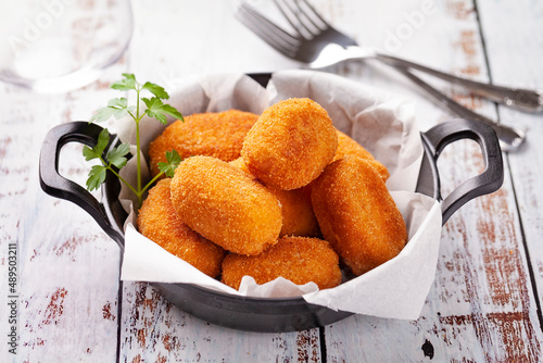Tapa of croquettes on white table photo
