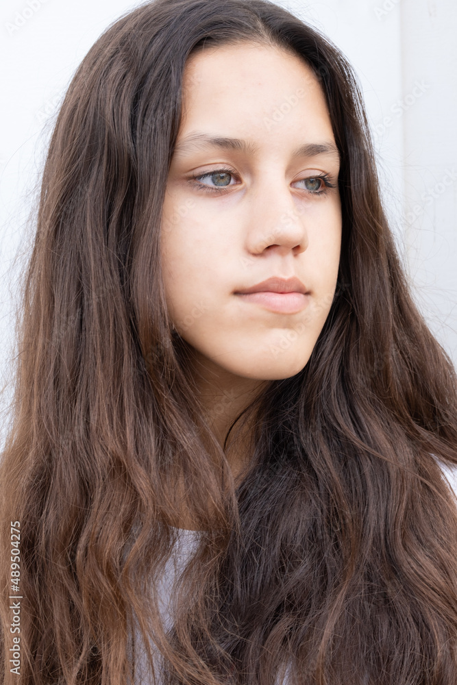 Young attractive girl with grey eyes and dark open hair looking away Young attractive girl with grey eyes and dark open hair looking away