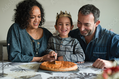 Family in front of a king cake