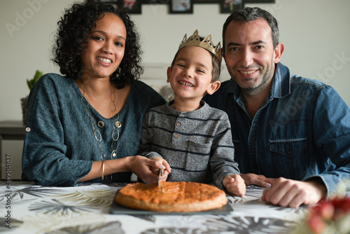 Family in front of a king cake