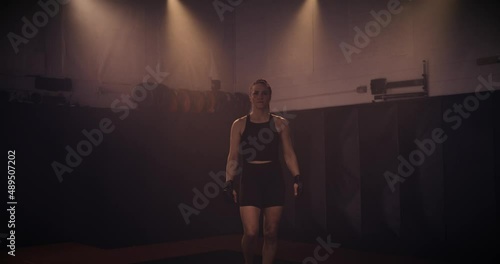 A Slow Motion Portrait Of A Strong Female Boxer In An MMA Gym. Shot In A Crossfit Boxing Gym With Low Key Lighting And A Scattering Of Haze. Captured On Red Digital Cinema Camera 