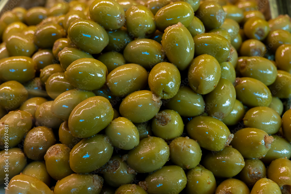 Green fresh olives close up on market, food background Green fresh olives close up on market, food background