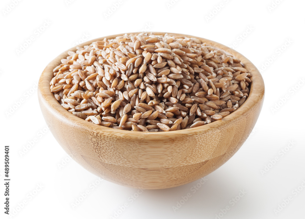 Grains of spelt in wooden bowl isolated on white background wiht clipping path Grains of spelt in wooden bowl isolated on white background wiht clipping path