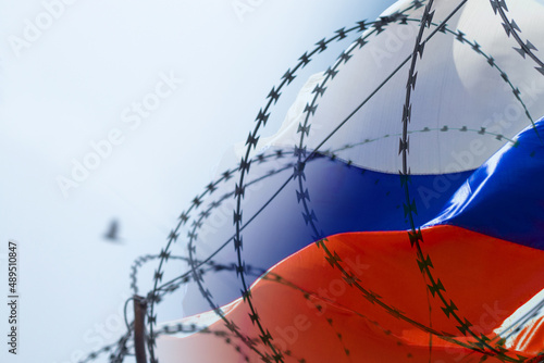 Flag of Russia on the background of barbed wire. Martial law in Ukraine. Stop war photo