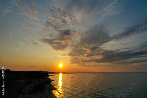 Beautiful orange sunset over the water. The Gulf of Finland. Coastal area Aerial view Coastline