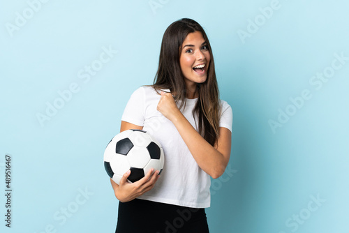 Young football player brazilian girl isolated on blue background celebrating a victory © luismolinero