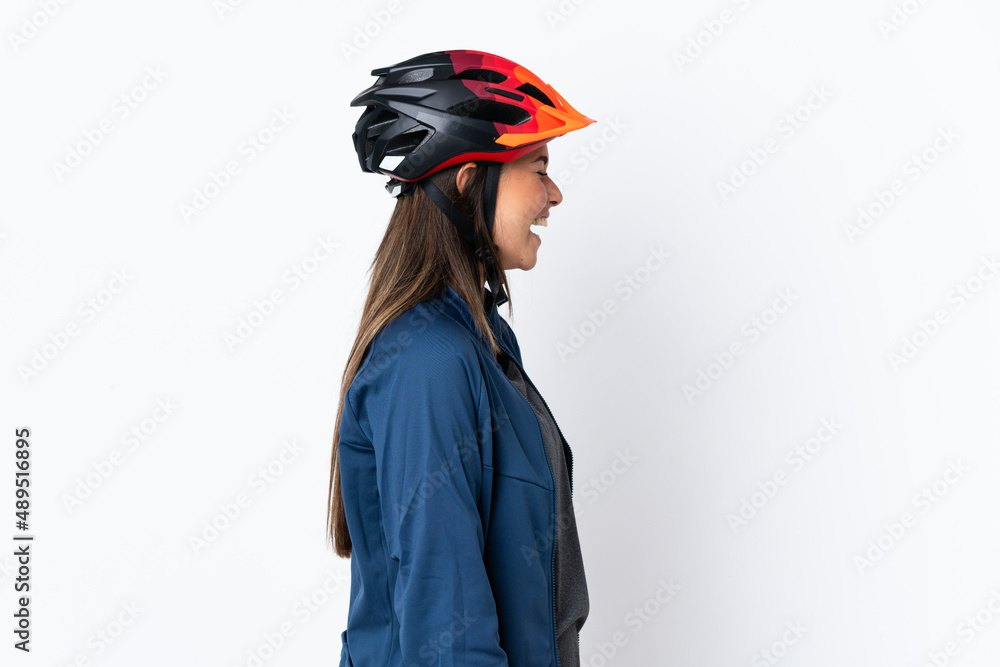 Young cyclist brazilian girl isolated on white background laughing in lateral position Young cyclist brazilian girl isolated on white background laughing in lateral position