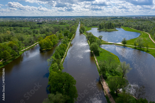 A panoramic view from a height of the ponds and the Landscape Park in Peterhof  the meadow garden  walking paths  the destroyed pavilion.