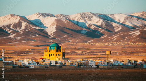 Soltaniyeh Mosque, Zanjan Province in Iran at the foot of the snowy mountains photo