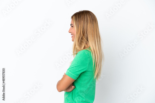 Blonde Uruguayan girl isolated on white background in lateral position