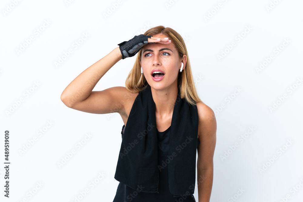 Blonde Uruguayan sport girl isolated on white background looking far away with hand to look something Blonde Uruguayan sport girl isolated on white background looking far away with hand to look something