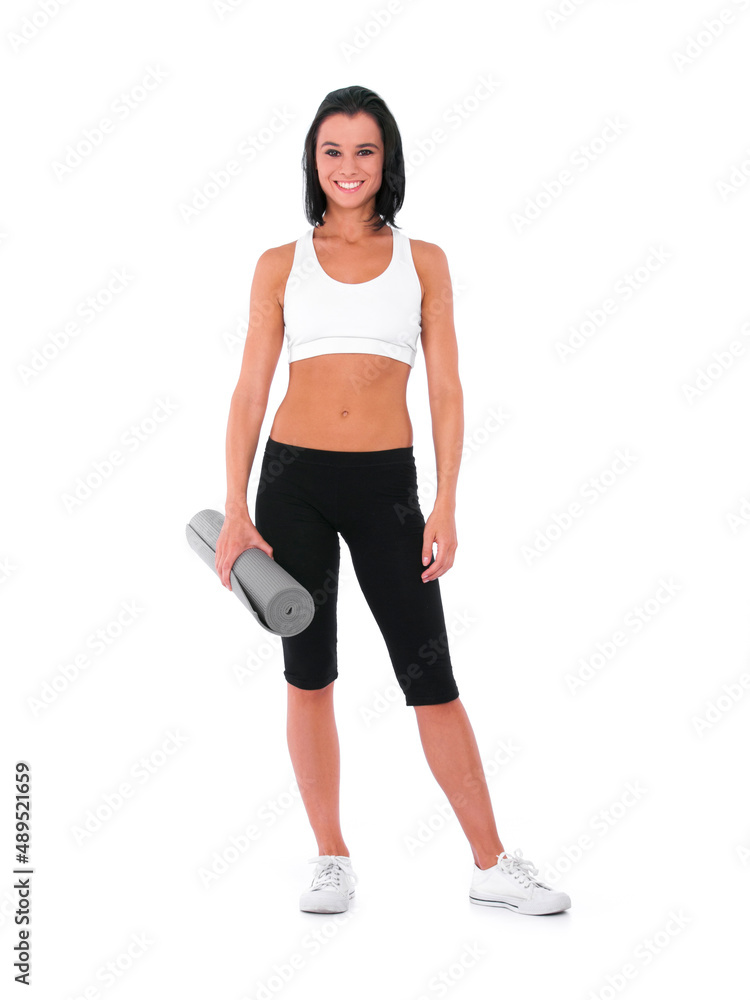 Shes in great shape. A healthy young woman smiling while holding a yoga mat - Isolated on white. Shes in great shape. A healthy young woman smiling while holding a yoga mat - Isolated on white.