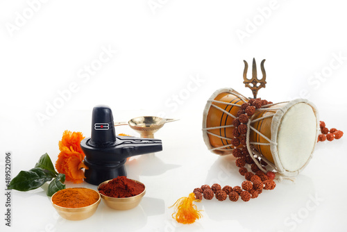 Happy Maha Shivaratri greeting card - Shiva Linga decorated with flowers, trishula, damru and bilva leaves. Hindu festival celebrated of Shiva Lord photo