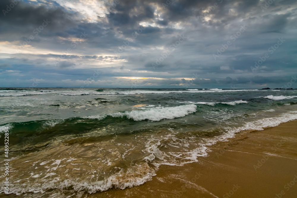 Summer landscape on the sandy shore of the Indian Ocean against the sky with clouds at sunset. Sri Lanka Summer landscape on the sandy shore of the Indian Ocean against the sky with clouds at sunset. Sri Lanka