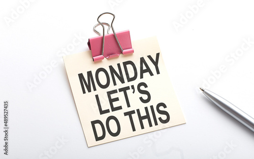 MONDAY LET'S DO THIS text on the sticker with pen on the white background