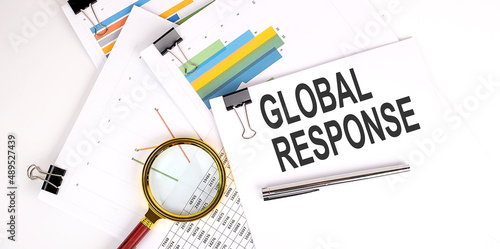 GLOBAL RESPONSE text on white paper on the light background with charts paper