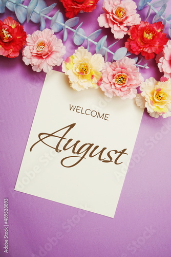 Welcome August typography text and flower decorate on purple background