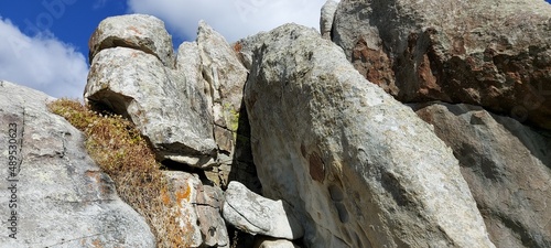A heap of gray rocks in a national park against a blue sky.